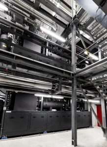 To get around space constraints, a mezzanine level was installed so the heat pumps could be stacked on top of each other. Photo credit: Fenagy