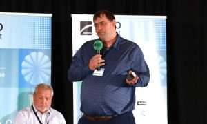An image of Brett Crask, Grocery Practice Director at Henderson Engineers, presenting at ATMO America 2026.